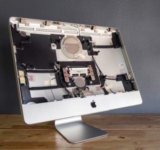 Apple iMac Disassembled for Repairs and Upgrades Disassembled Apple iMac computer showing internal components for repair and upgrades