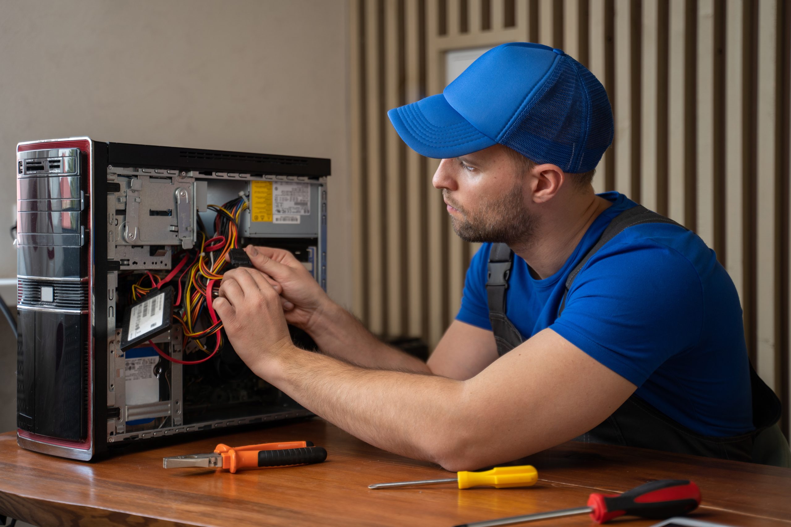 Professional Onsite Computer Repair and IT Support Technician repairing a desktop computer, representing onsite IT support and hardware troubleshooting services.