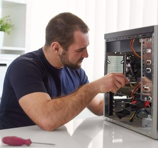 Professional Computer Repair Technician Technician repairing a desktop computer with precision tools