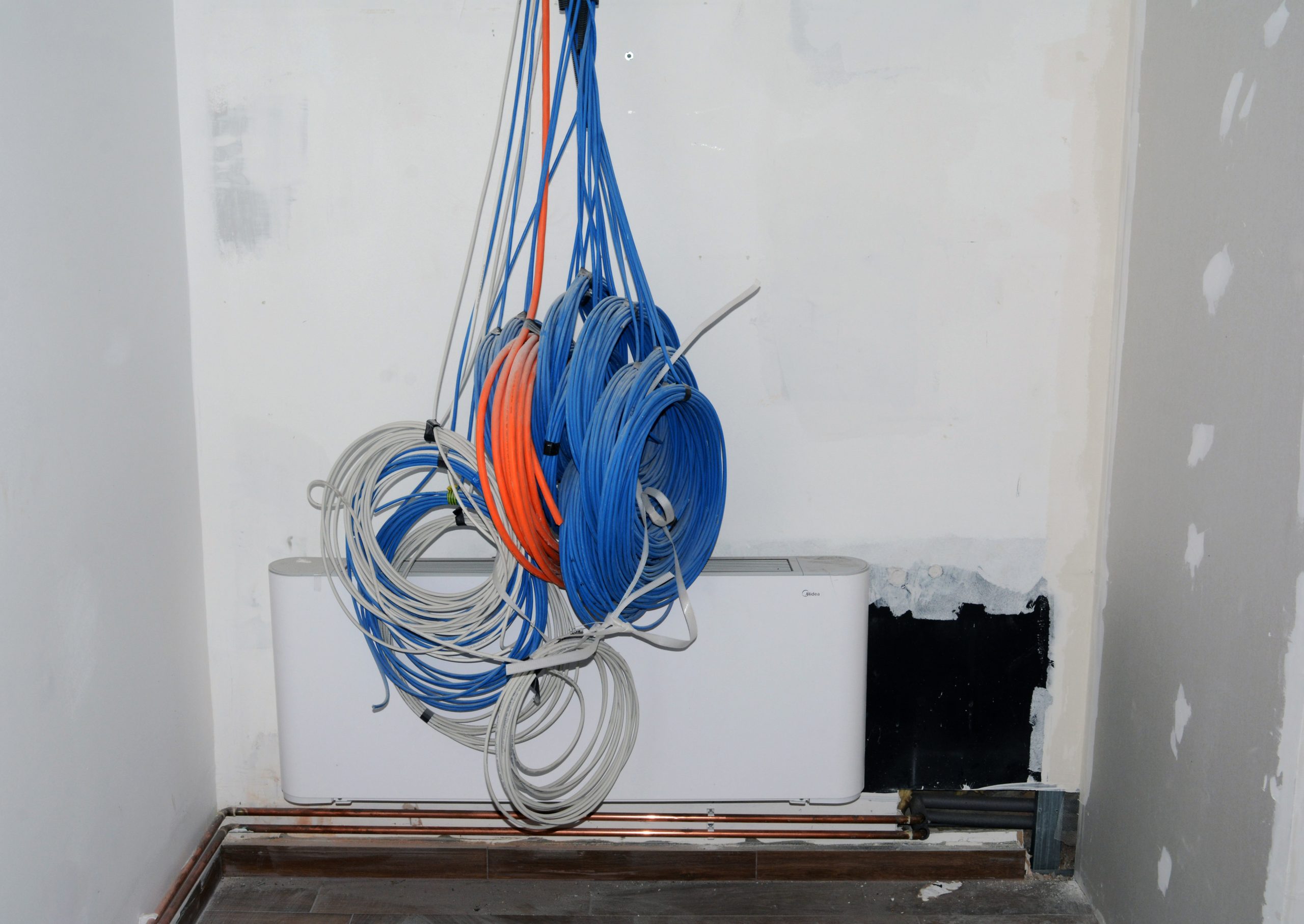 Coiled Network Cables Ready for Installation Neatly coiled network cables hanging on a wall, ready for professional installation