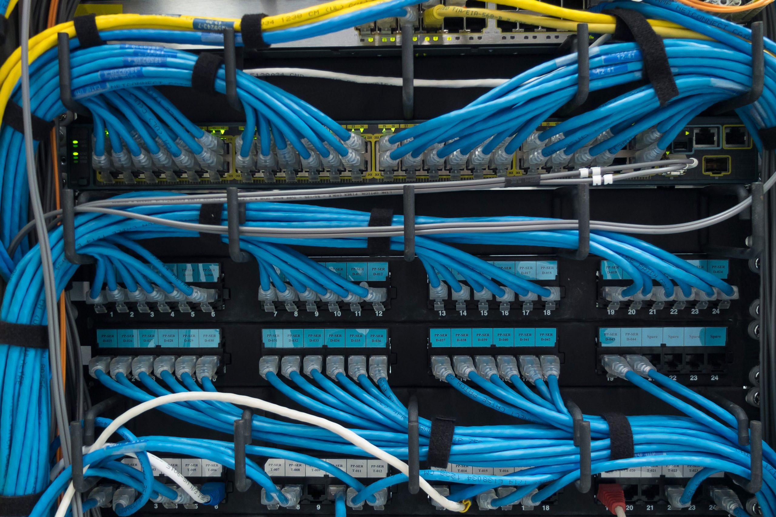 Organized Network Cables in a Server Rack Organized blue network cables in a server rack with efficient labeling and connectivity