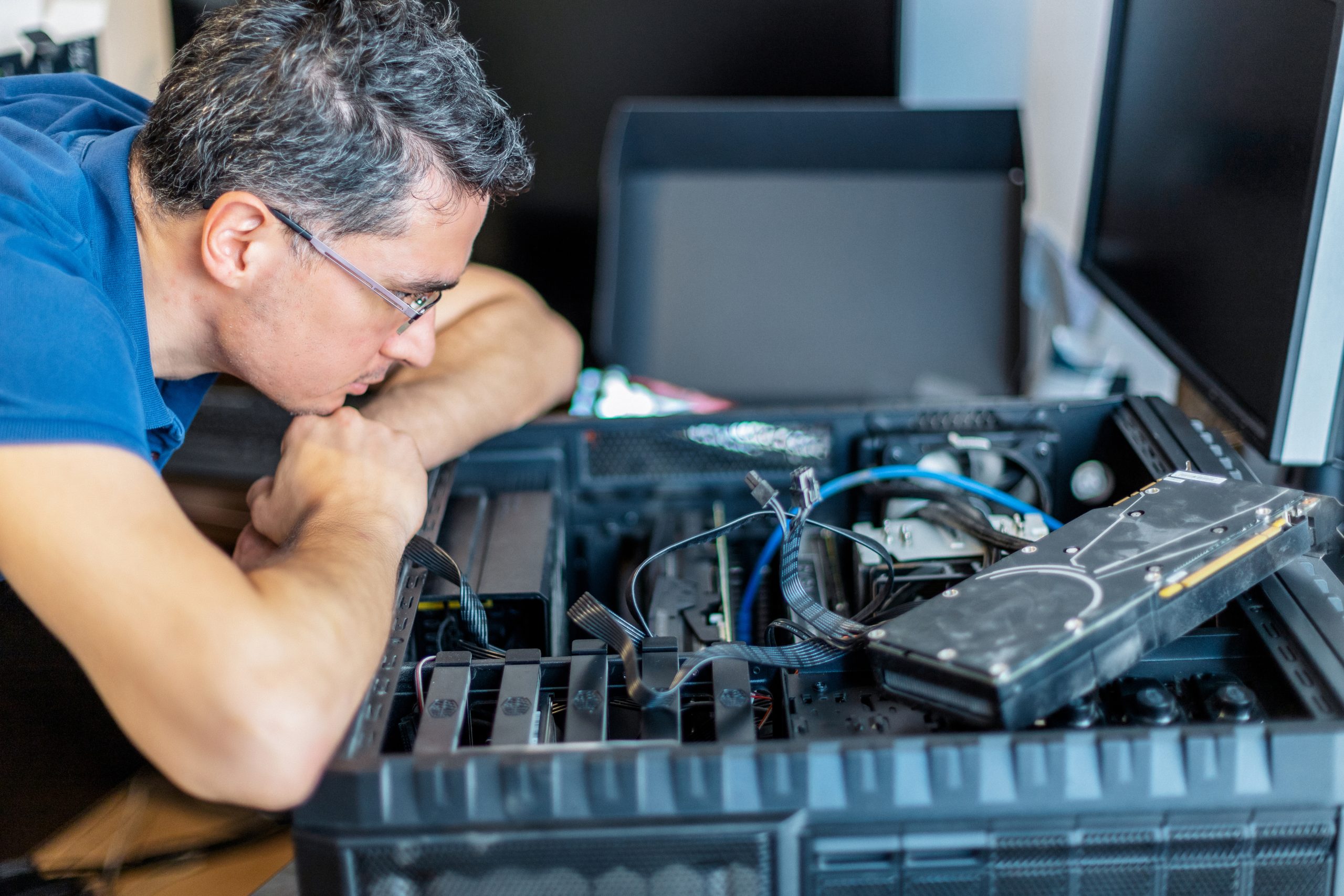 Expert PC Hardware Diagnostics in Action Technician carefully diagnosing PC hardware components to identify and resolve issues.