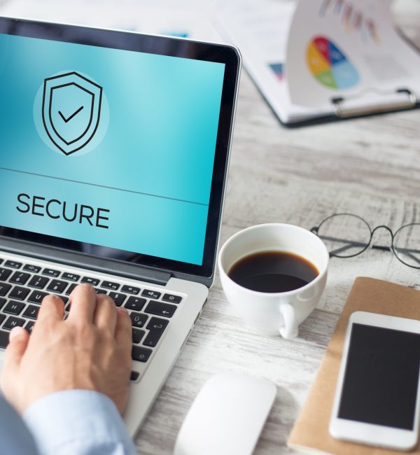 Cybersecurity for Secure Laptops and Data Protection Hands typing on a laptop displaying a secure shield icon, representing cybersecurity and IT protection for personal and business devices.