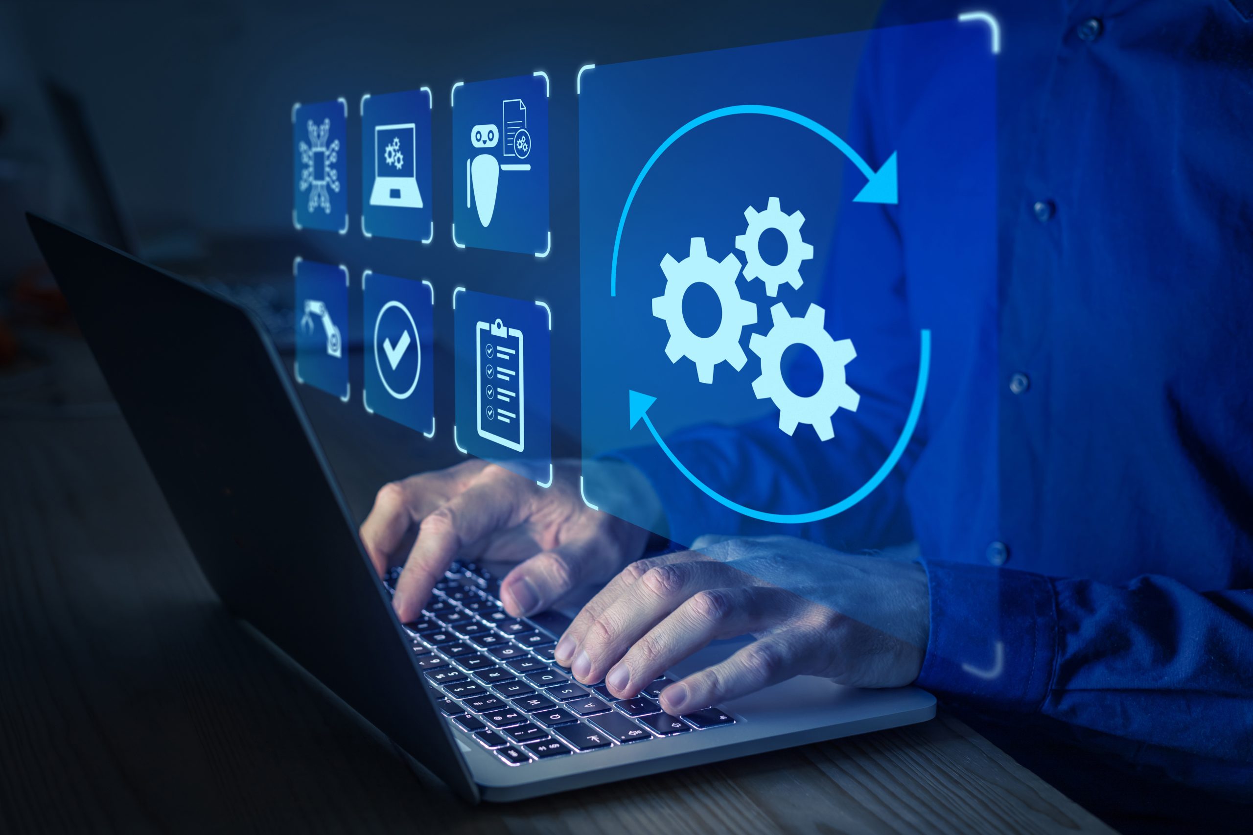 System Optimization and Software Upgrade Hands typing on a laptop with digital icons representing system optimization and software upgrades.