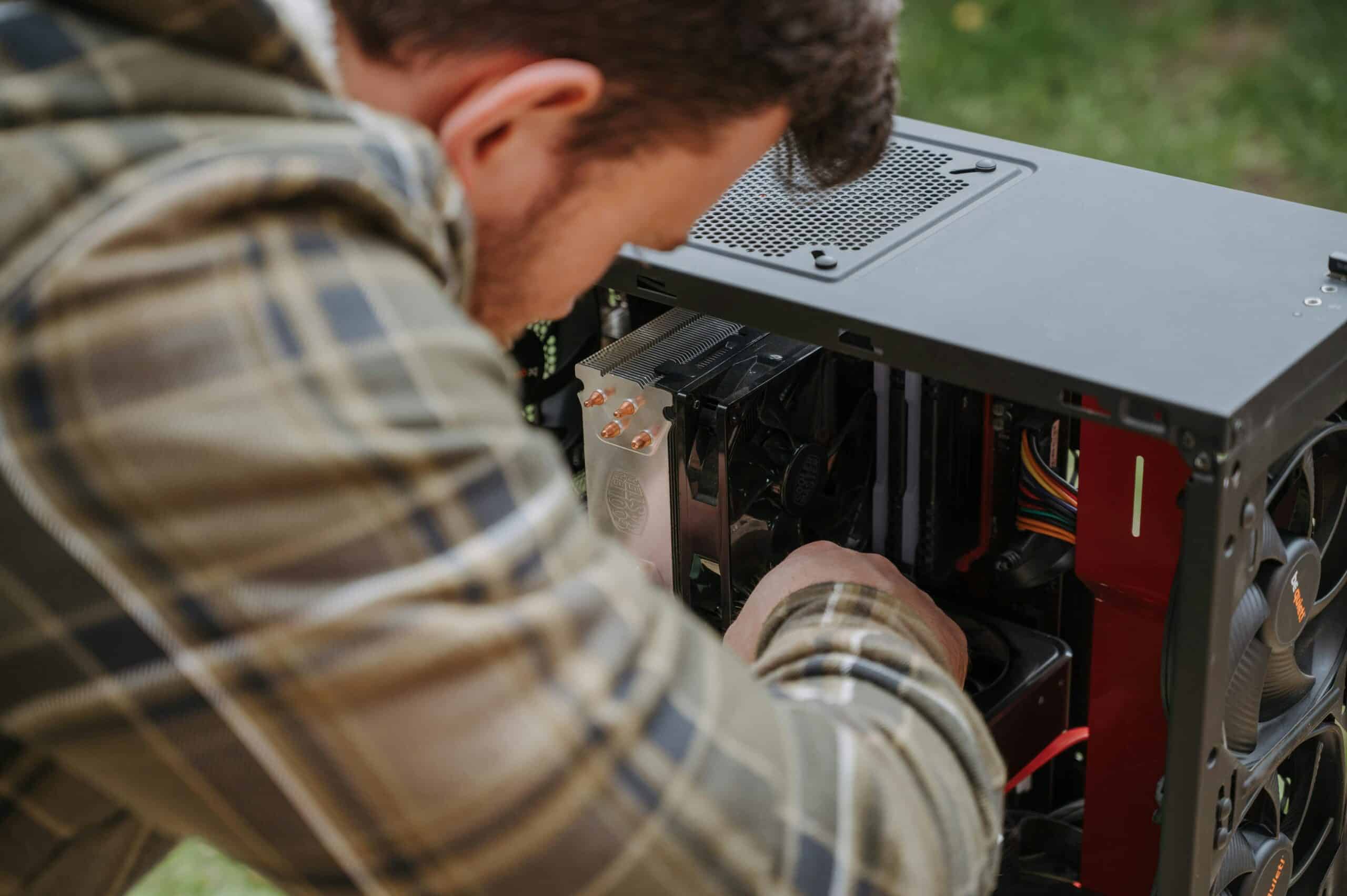 IT technician repairing desktop computer hardware during onsite computer repair service in Aurora CO
